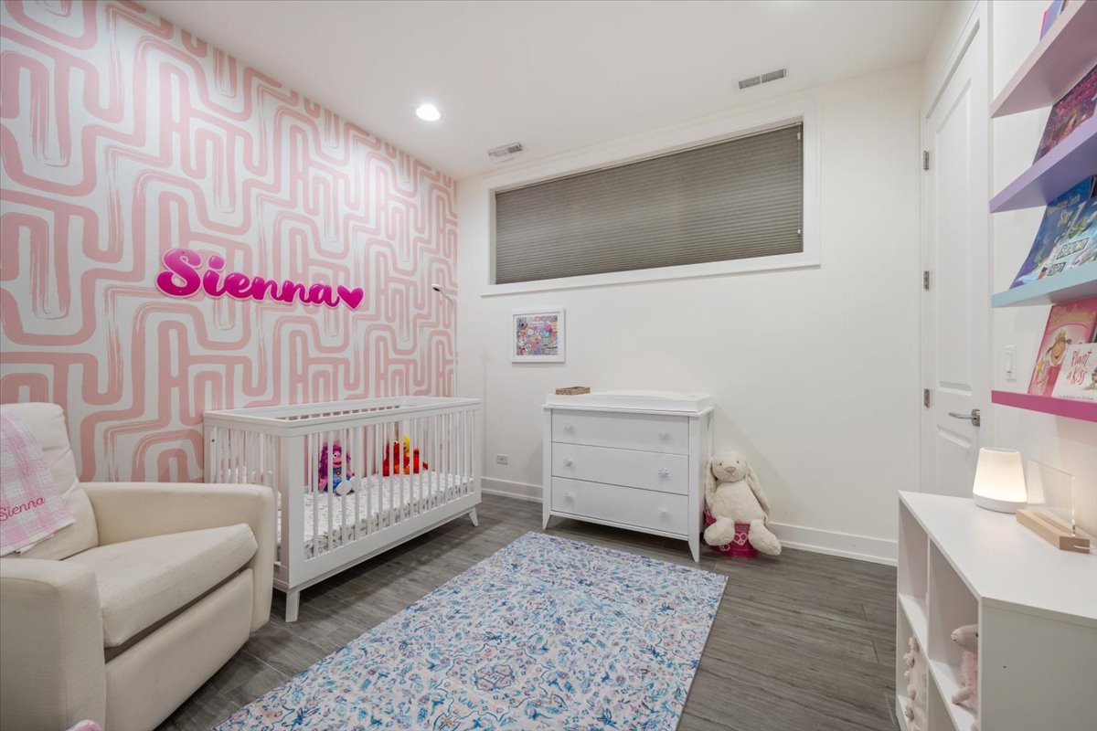 951 North Winchester Avenue, Unit 1 Chicago, IL 60622 - Photo 21 of 28 a bedroom with a bed and a couch