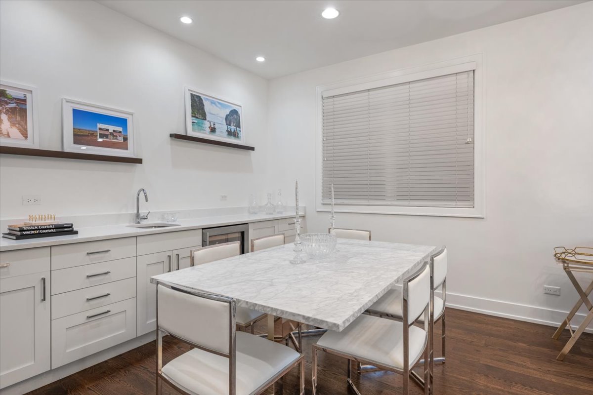 951 North Winchester Avenue, Unit 1 Chicago, IL 60622 - Photo 6 of 28 a kitchen with a table chairs and white cabinets