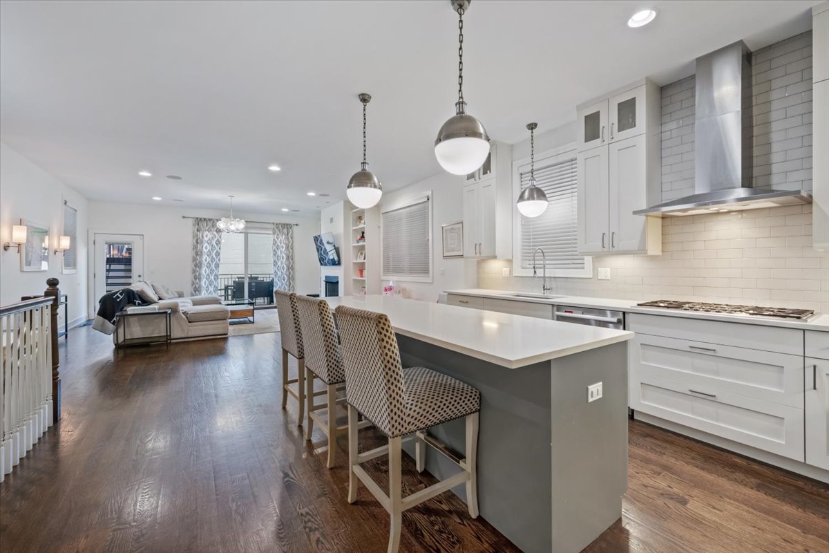 951 North Winchester Avenue, Unit 1 Chicago, IL 60622 - Photo 7 of 28 a kitchen with a dining table chairs stove and white cabinets