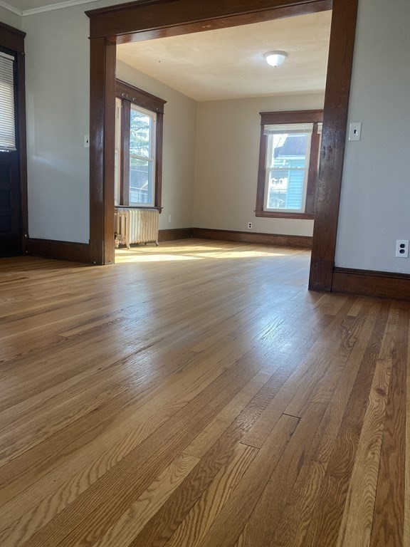 76-78 Ardmore Street Springfield, MA 01104 - Photo 11 of 20 an empty room with wooden floor and windows