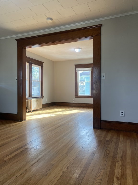 76-78 Ardmore Street Springfield, MA 01104 - Photo 12 of 20 an empty room with wooden floor and windows
