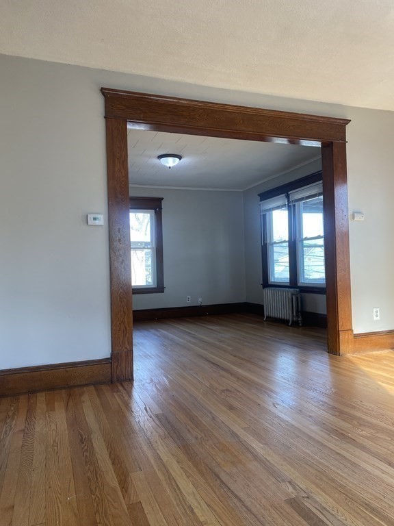 76-78 Ardmore Street Springfield, MA 01104 - Photo 13 of 20 an empty room with wooden floor and windows