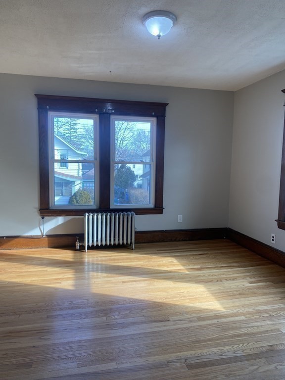 76-78 Ardmore Street Springfield, MA 01104 - Photo 14 of 20 a view of an empty room with wooden floor and a window