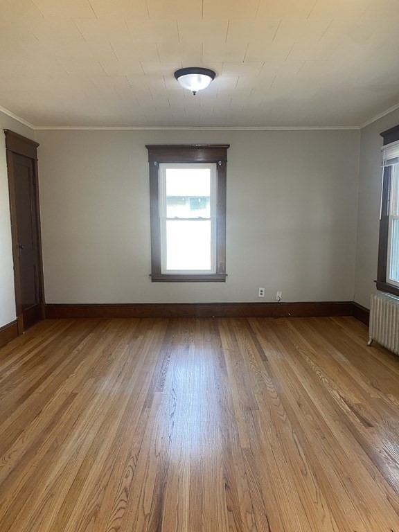 76-78 Ardmore Street Springfield, MA 01104 - Photo 15 of 20 an empty room with wooden floor and windows