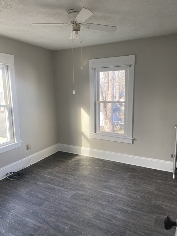 76-78 Ardmore Street Springfield, MA 01104 - Photo 16 of 20 a view of an empty room with wooden floor and a window