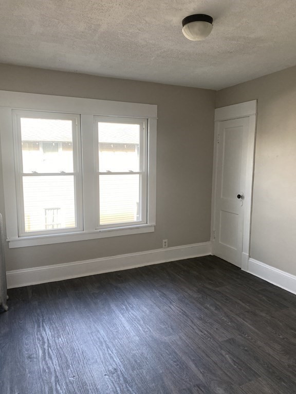 76-78 Ardmore Street Springfield, MA 01104 - Photo 18 of 20 an empty room with wooden floor and windows