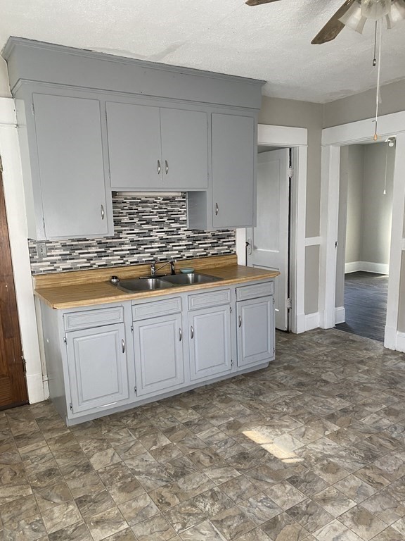 76-78 Ardmore Street Springfield, MA 01104 - Photo 6 of 20 a kitchen with a stove and white cabinets