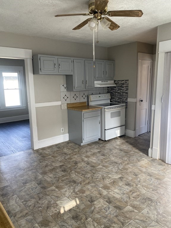 76-78 Ardmore Street Springfield, MA 01104 - Photo 8 of 20 a view of a kitchen with a sink cabinets and window