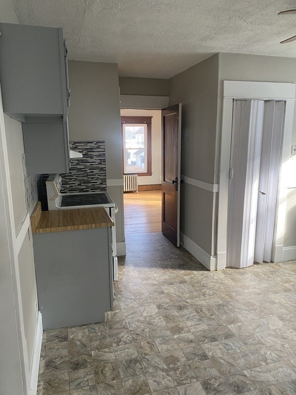76-78 Ardmore Street Springfield, MA 01104 - Photo 9 of 20 a view of a kitchen with a sink dishwasher and a refrigerator