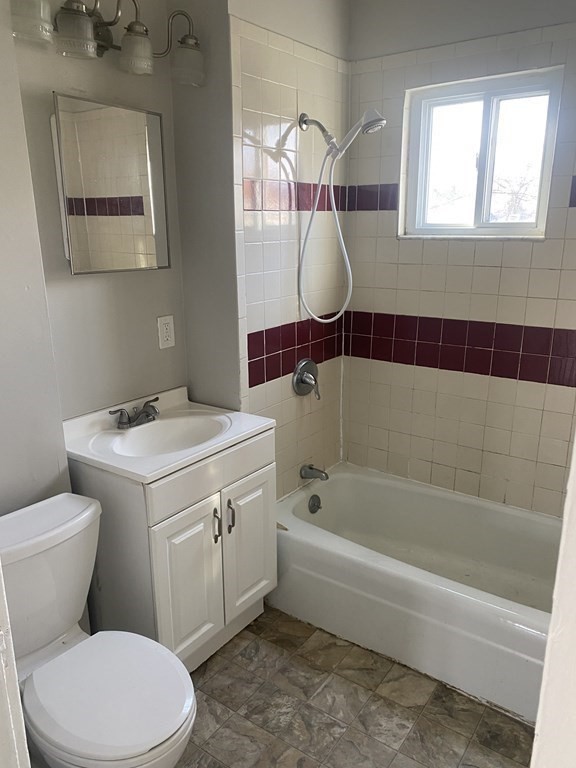 76-78 Ardmore Street Springfield, MA 01104 - Photo 10 of 20 a bathroom with a toilet sink and mirror