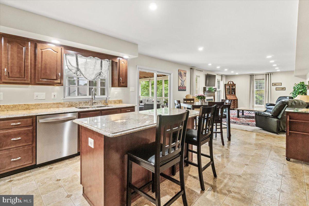 2218 West Greenleaf Drive Frederick, MD 21702 - Photo 14 of 46 a open kitchen with stainless steel appliances granite countertop table chairs stove and sink