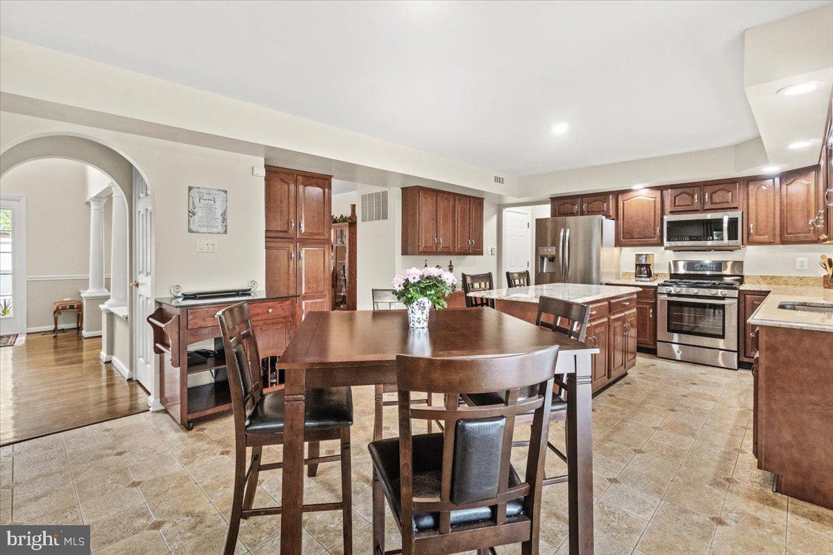 2218 West Greenleaf Drive Frederick, MD 21702 - Photo 17 of 46 a large kitchen with a table and chairs in it