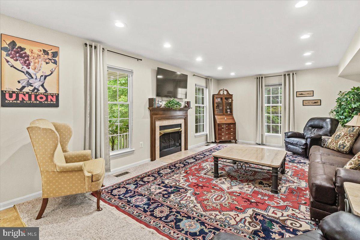 2218 West Greenleaf Drive Frederick, MD 21702 - Photo 18 of 46 a living room with furniture and a fireplace