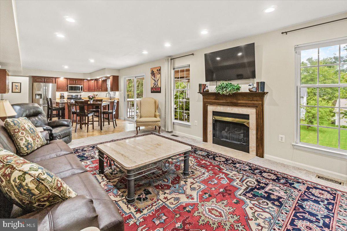 2218 West Greenleaf Drive Frederick, MD 21702 - Photo 20 of 46 a living room with furniture and a fireplace