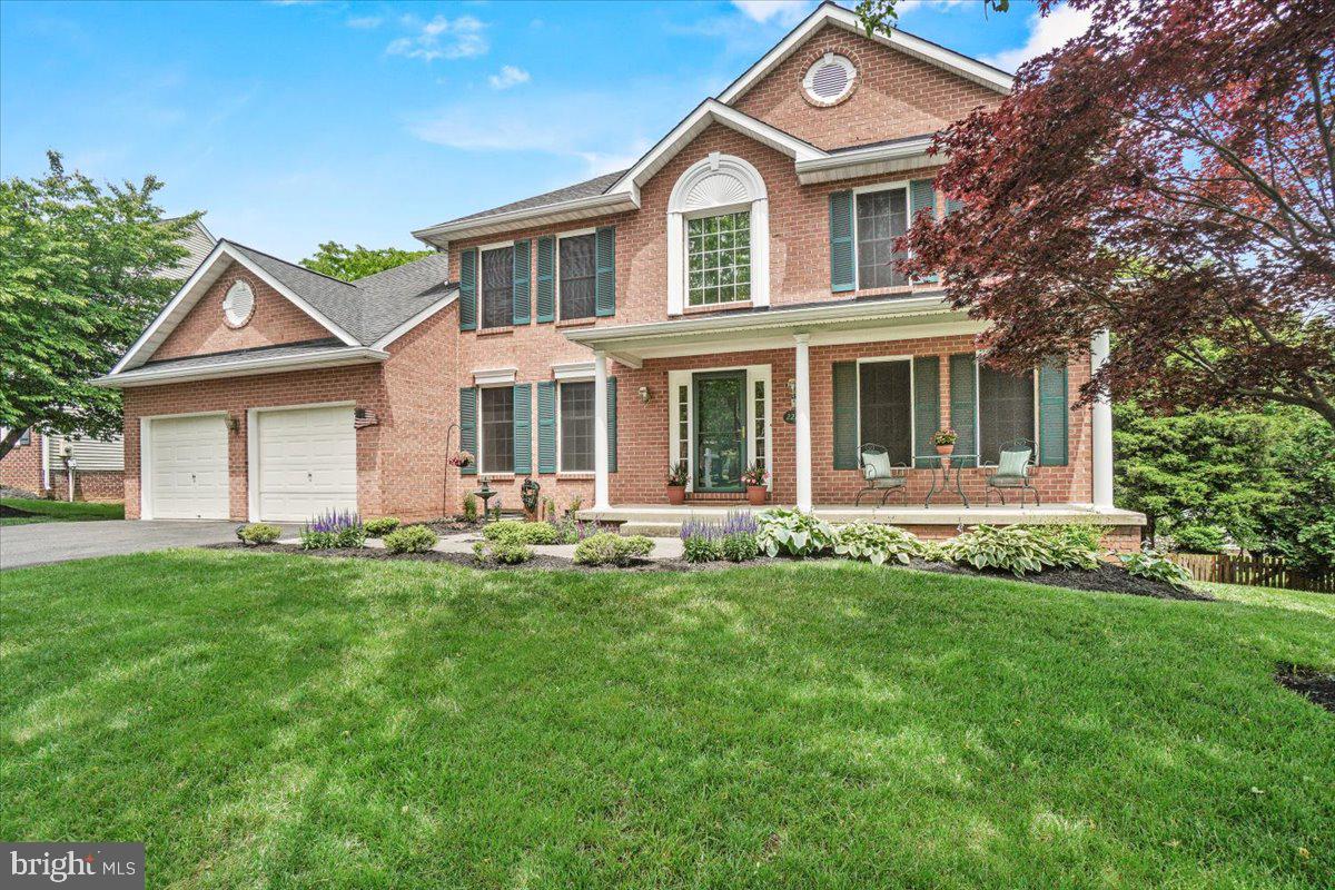 2218 West Greenleaf Drive Frederick, MD 21702 - Photo 2 of 46 a front view of a house with a garden
