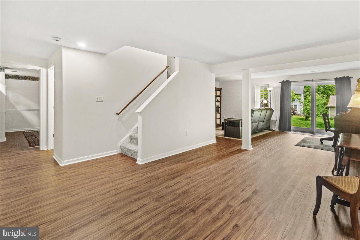 2218 West Greenleaf Drive Frederick, MD 21702 - Photo 21 of 46 a view of an empty room with wooden floor and a window