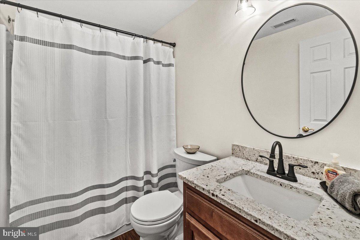 2218 West Greenleaf Drive Frederick, MD 21702 - Photo 25 of 46 a bathroom with a sink a toilet and a mirror