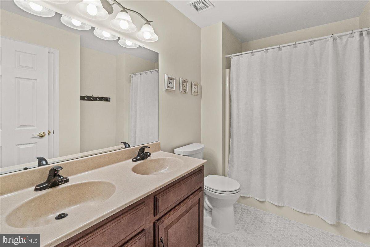 2218 West Greenleaf Drive Frederick, MD 21702 - Photo 28 of 46 a bathroom with a double vanity sink mirror and toilet