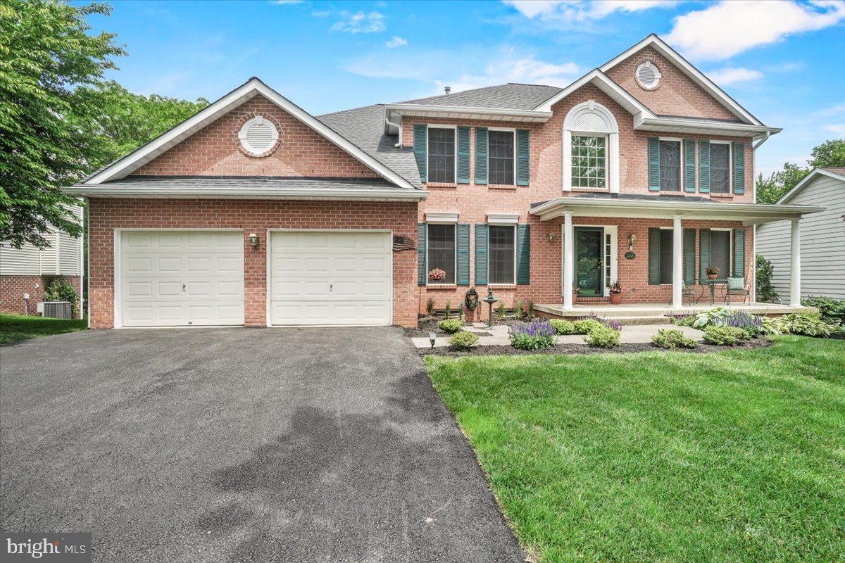 2218 West Greenleaf Drive Frederick, MD 21702 - Photo 3 of 46 a front view of a house with a yard and garage