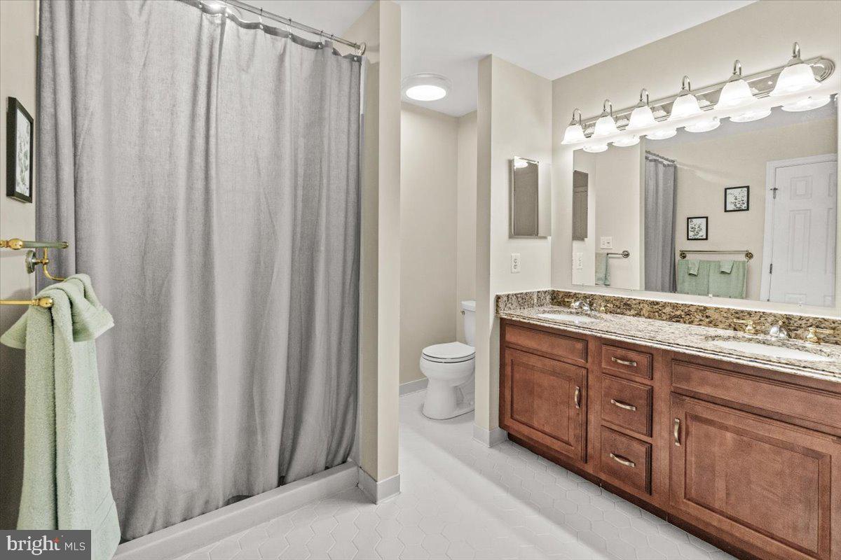 2218 West Greenleaf Drive Frederick, MD 21702 - Photo 33 of 46 a spacious bathroom with a double vanity sink and a mirror