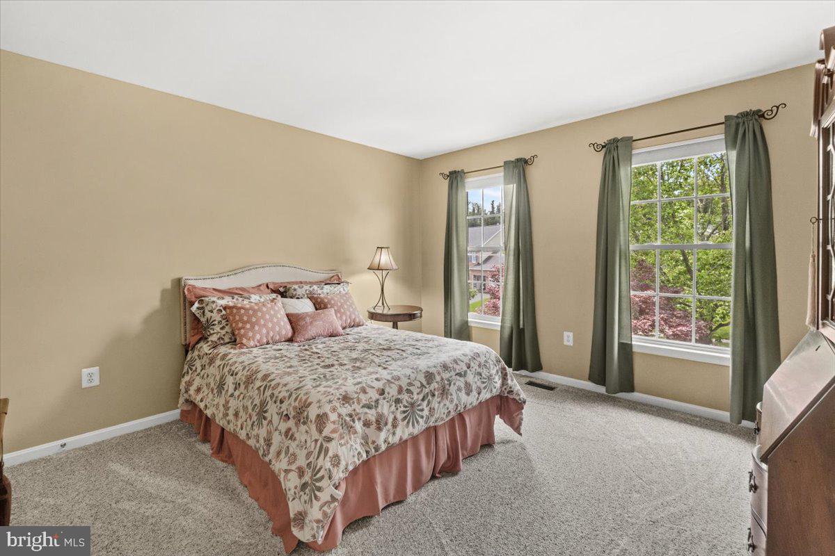 2218 West Greenleaf Drive Frederick, MD 21702 - Photo 35 of 46 a bedroom with a bed lamp and a window