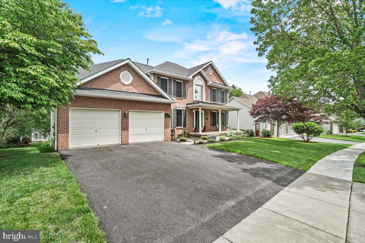 2218 West Greenleaf Drive Frederick, MD 21702 - Photo 41 of 46 a front view of a house with a yard and garage