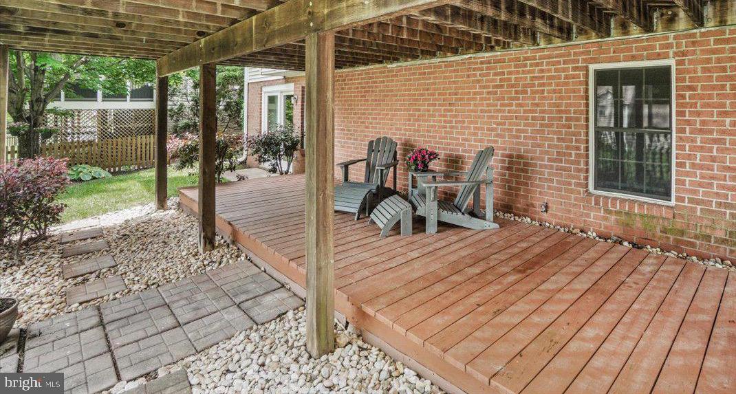 2218 West Greenleaf Drive Frederick, MD 21702 - Photo 45 of 46 a view of a patio with table and chairs with wooden floor and fence