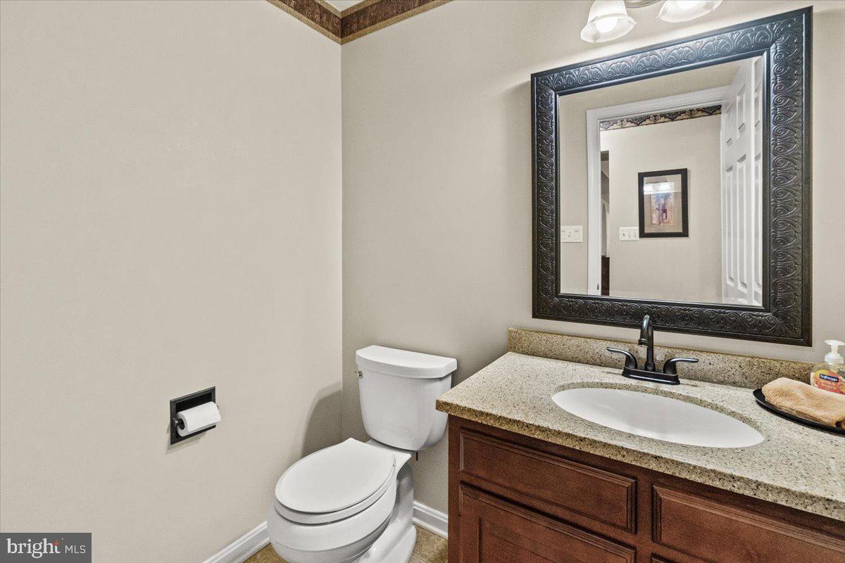 2218 West Greenleaf Drive Frederick, MD 21702 - Photo 9 of 46 a bathroom with a granite countertop sink toilet and mirror