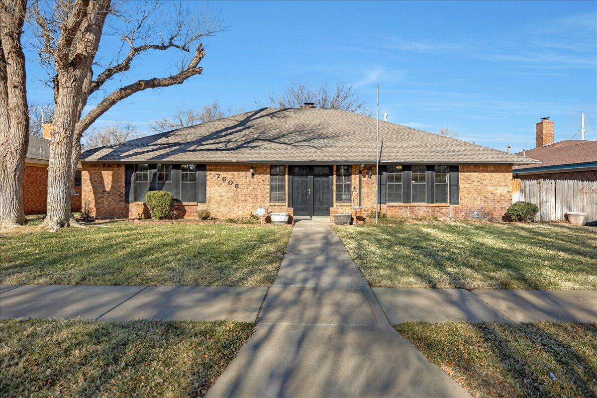 7606 Canode Drive Amarillo, TX 79121 - Photo 1 of 30 a front view of a house with a yard