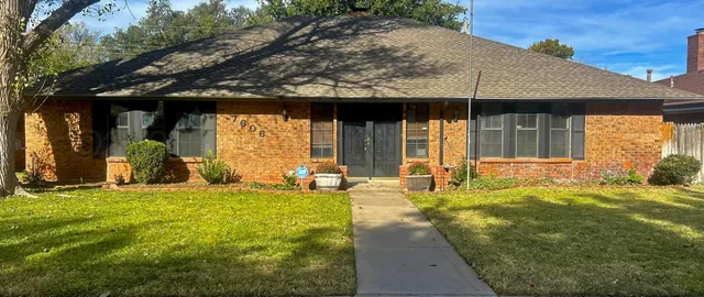 a view of a house with backyard porch and sitting area
