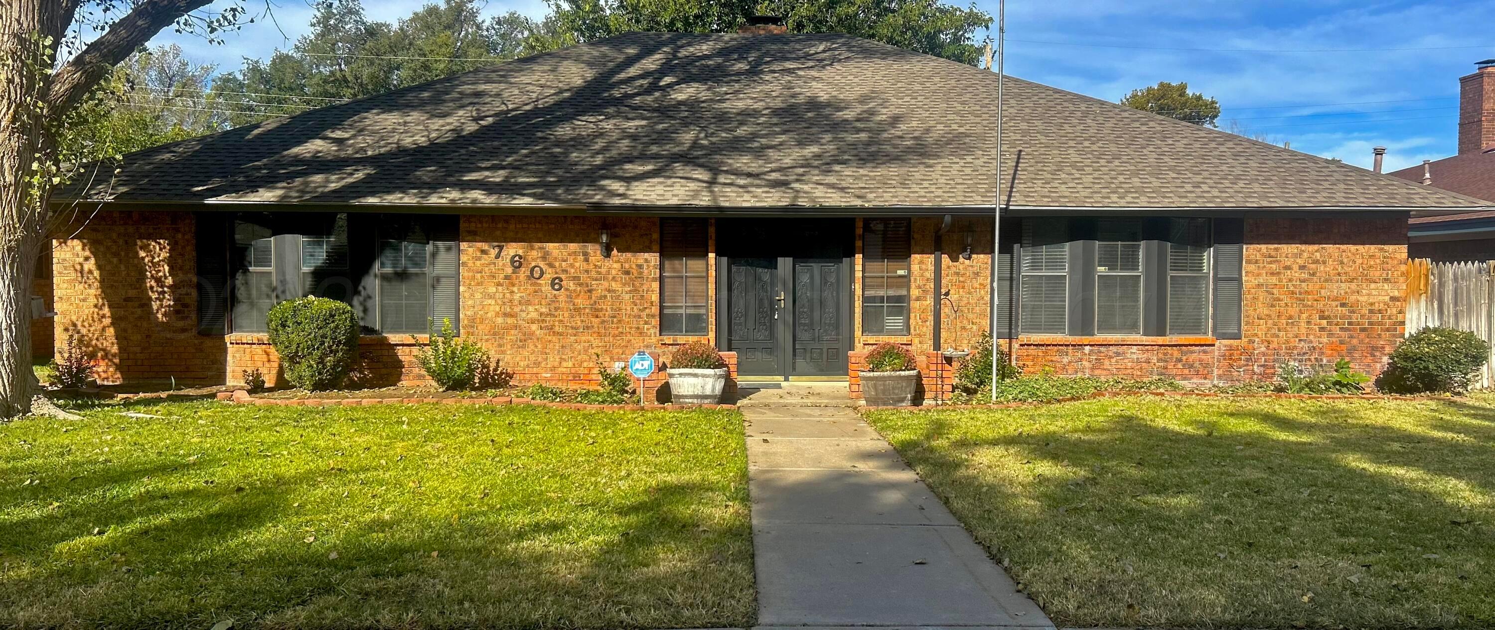 a view of a house with backyard porch and sitting area
