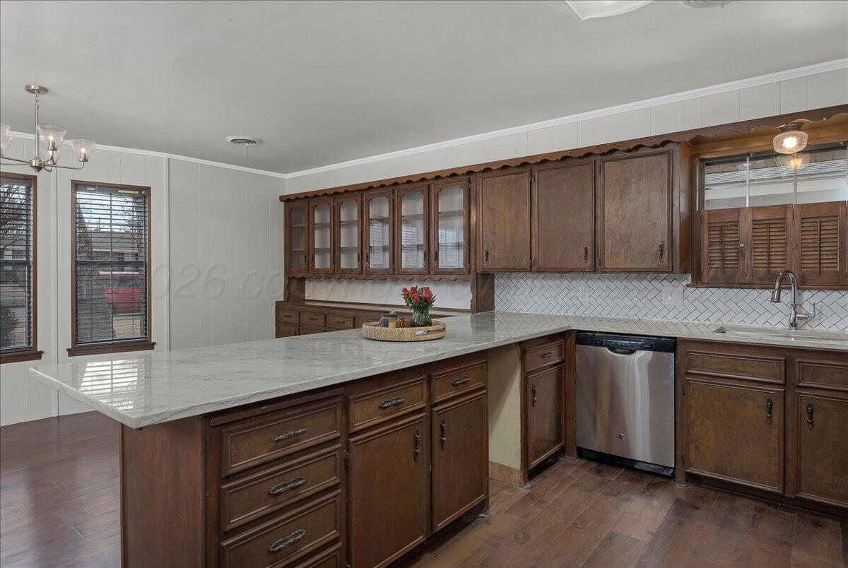7606 Canode Drive Amarillo, TX 79121 - Photo 11 of 30 a kitchen with stainless steel appliances granite countertop a sink and wooden cabinets with wooden floors