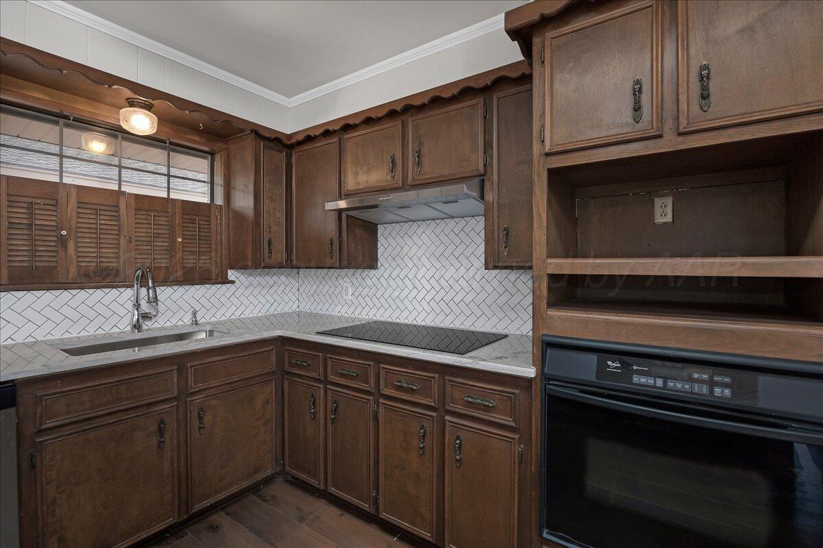 7606 Canode Drive Amarillo, TX 79121 - Photo 12 of 30 a kitchen with a sink and cabinets