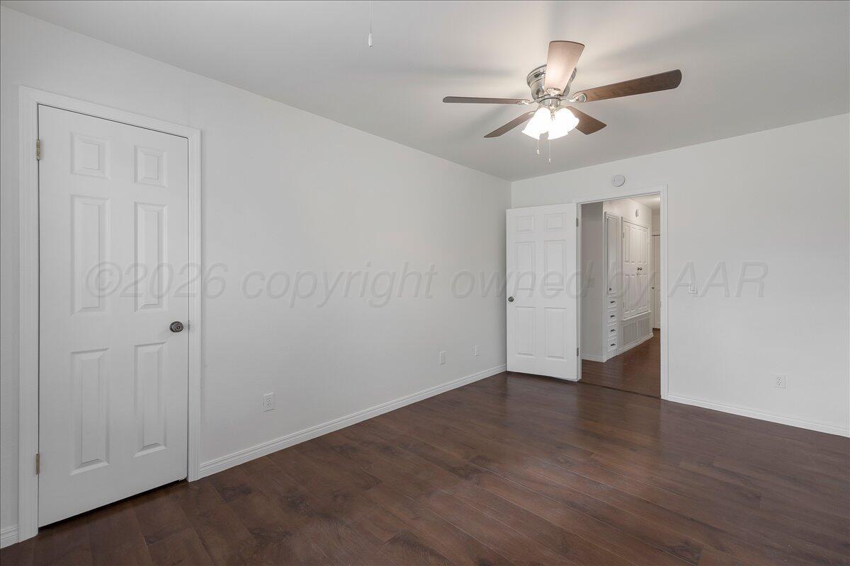 7606 Canode Drive Amarillo, TX 79121 - Photo 18 of 30 a view of an empty room with wooden floor