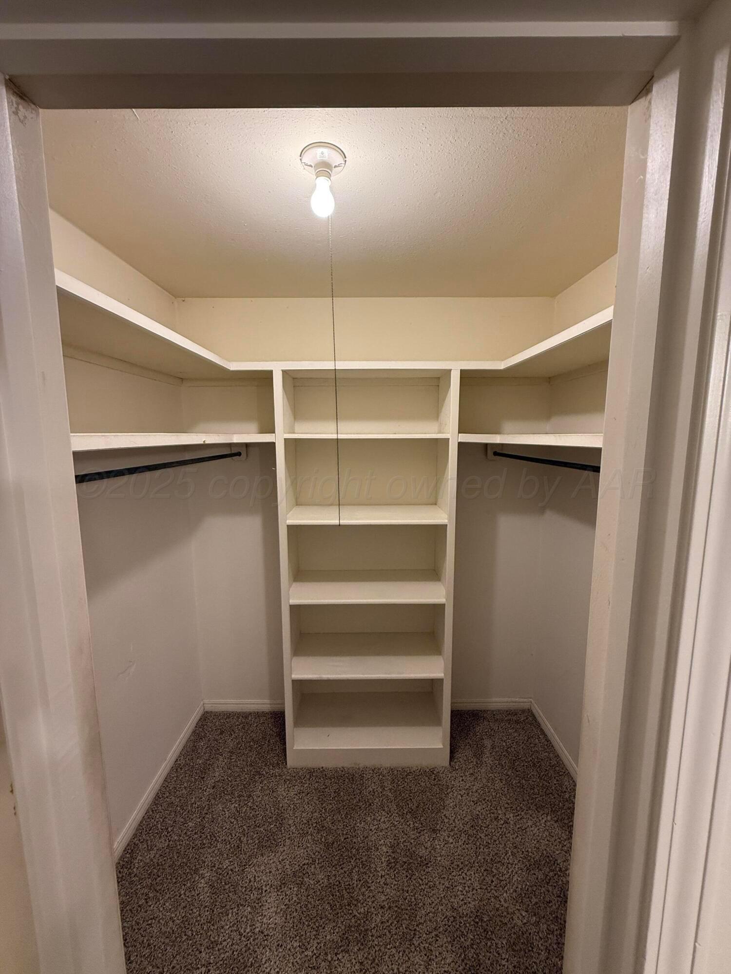7606 Canode Drive Amarillo, TX 79121 - Photo 18 of 20 a view of walk in closet with empty racks