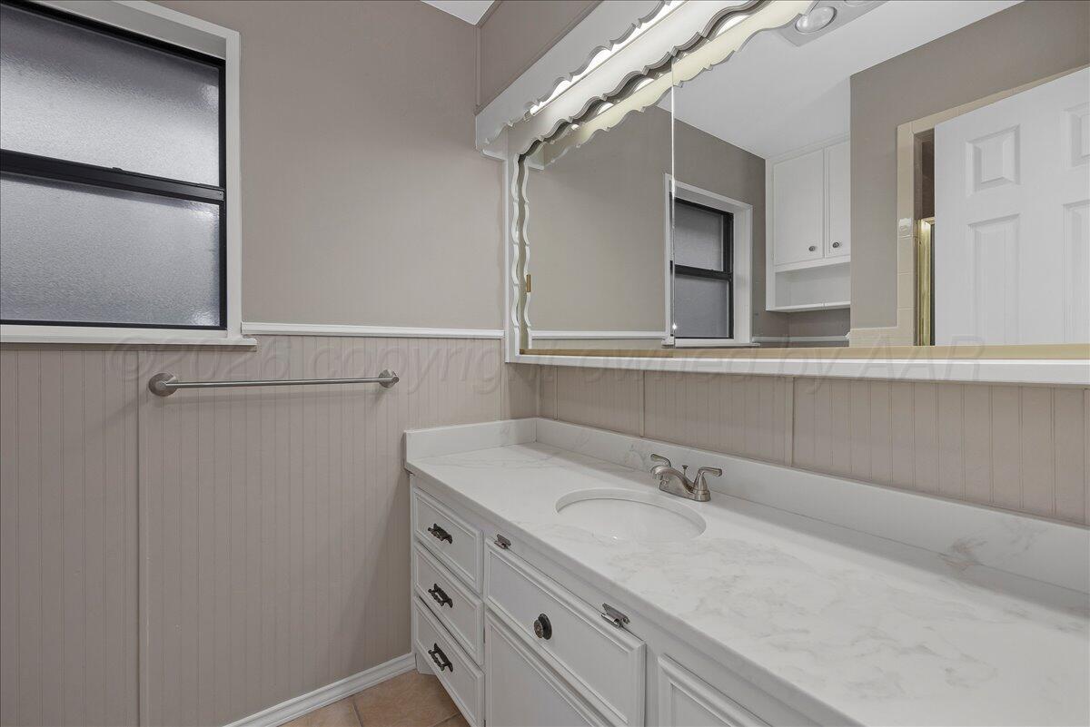 7606 Canode Drive Amarillo, TX 79121 - Photo 19 of 30 a bathroom with a sink and mirror