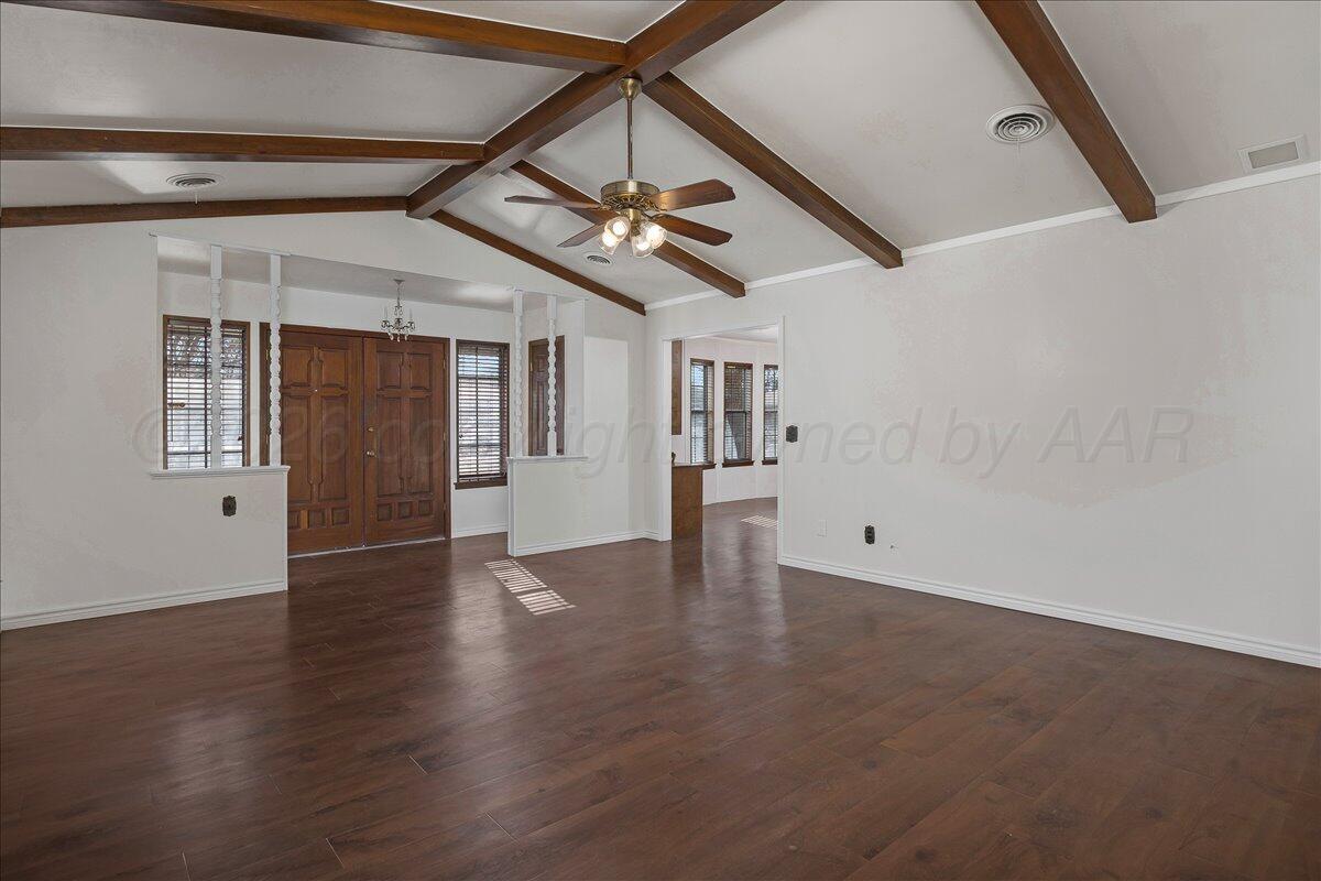 7606 Canode Drive Amarillo, TX 79121 - Photo 2 of 30 a view of an empty room with wooden floor and a ceiling fan