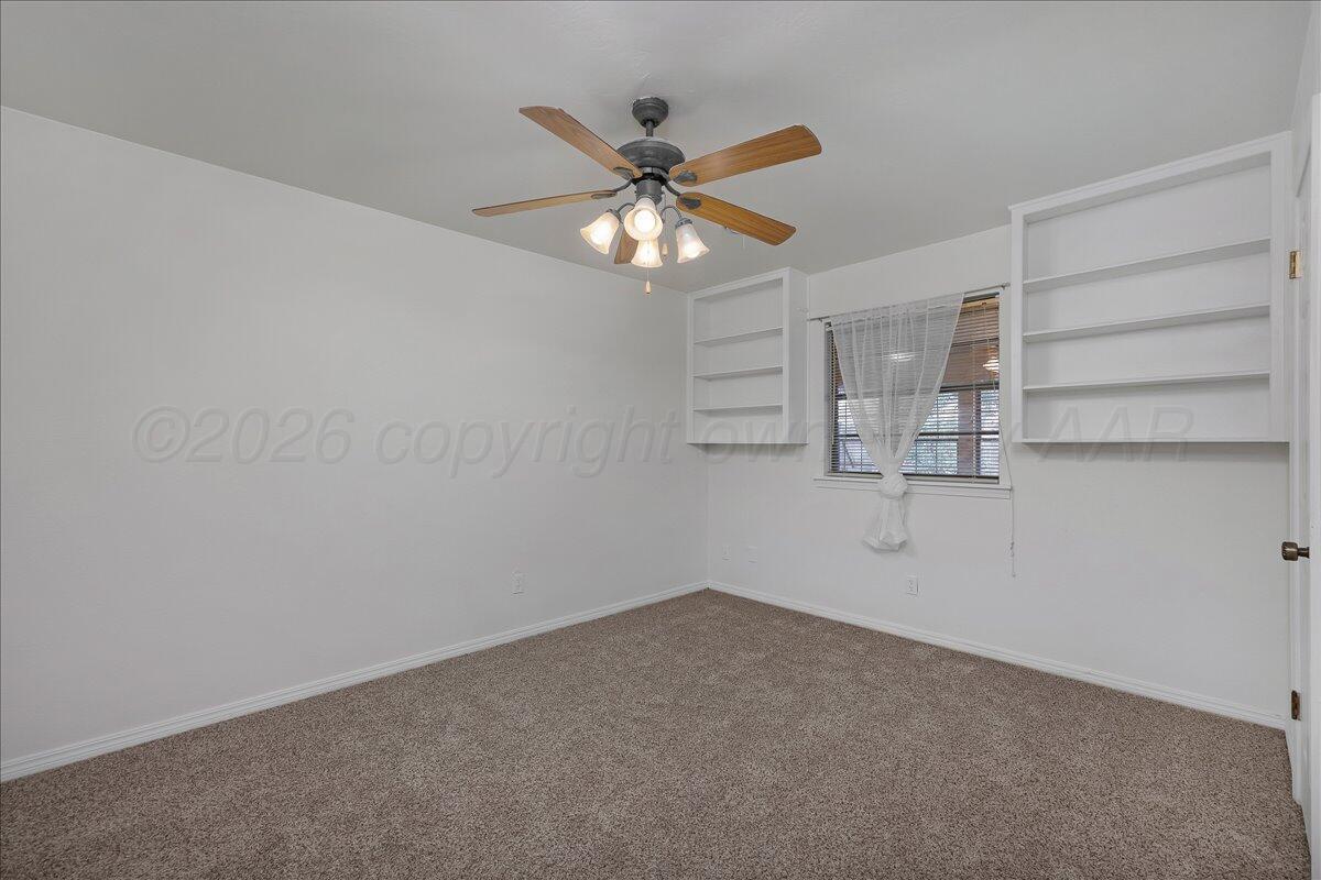7606 Canode Drive Amarillo, TX 79121 - Photo 21 of 30 wooden floor in an empty room with a window