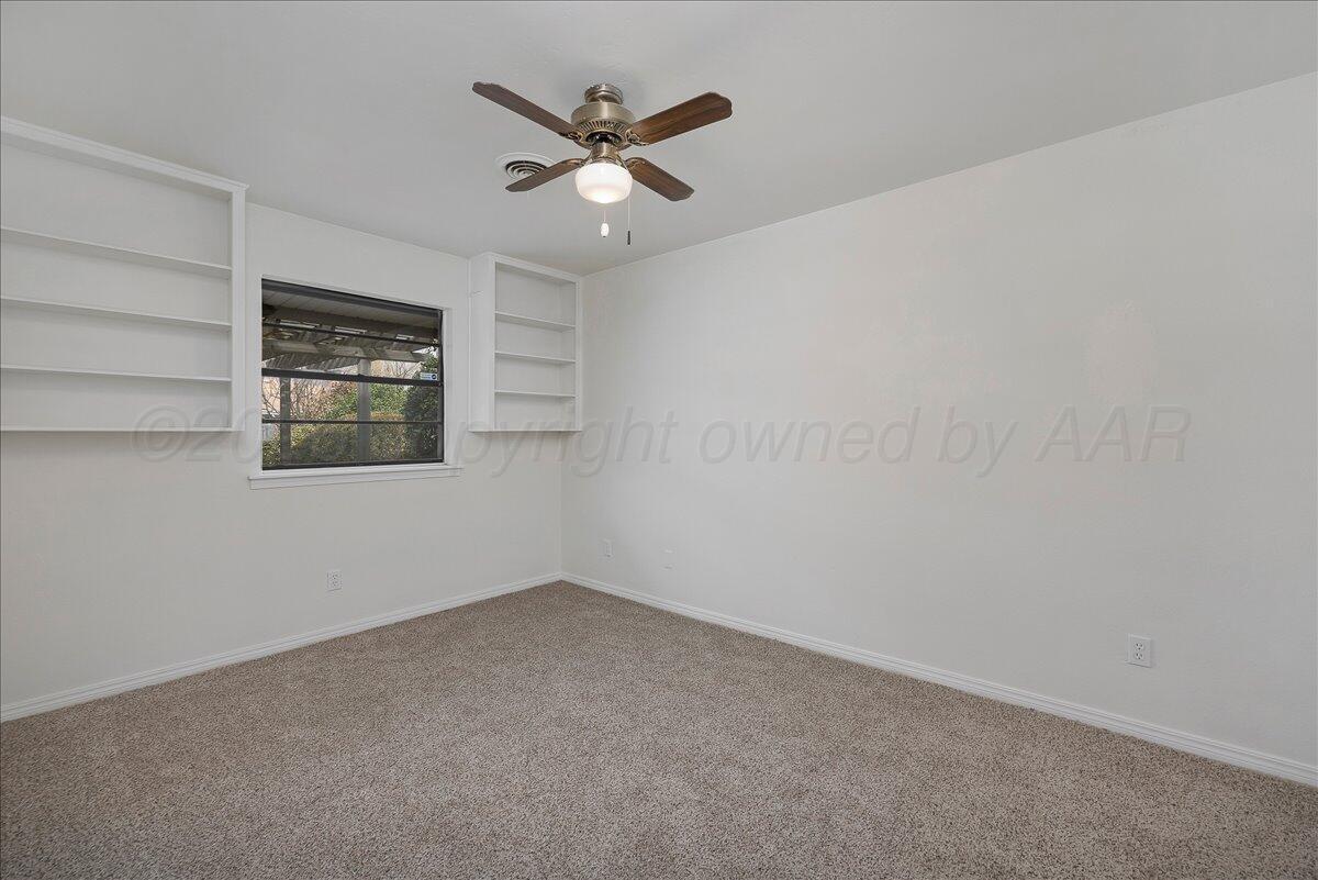 7606 Canode Drive Amarillo, TX 79121 - Photo 22 of 30 an empty room with a empty space and a ceiling fan