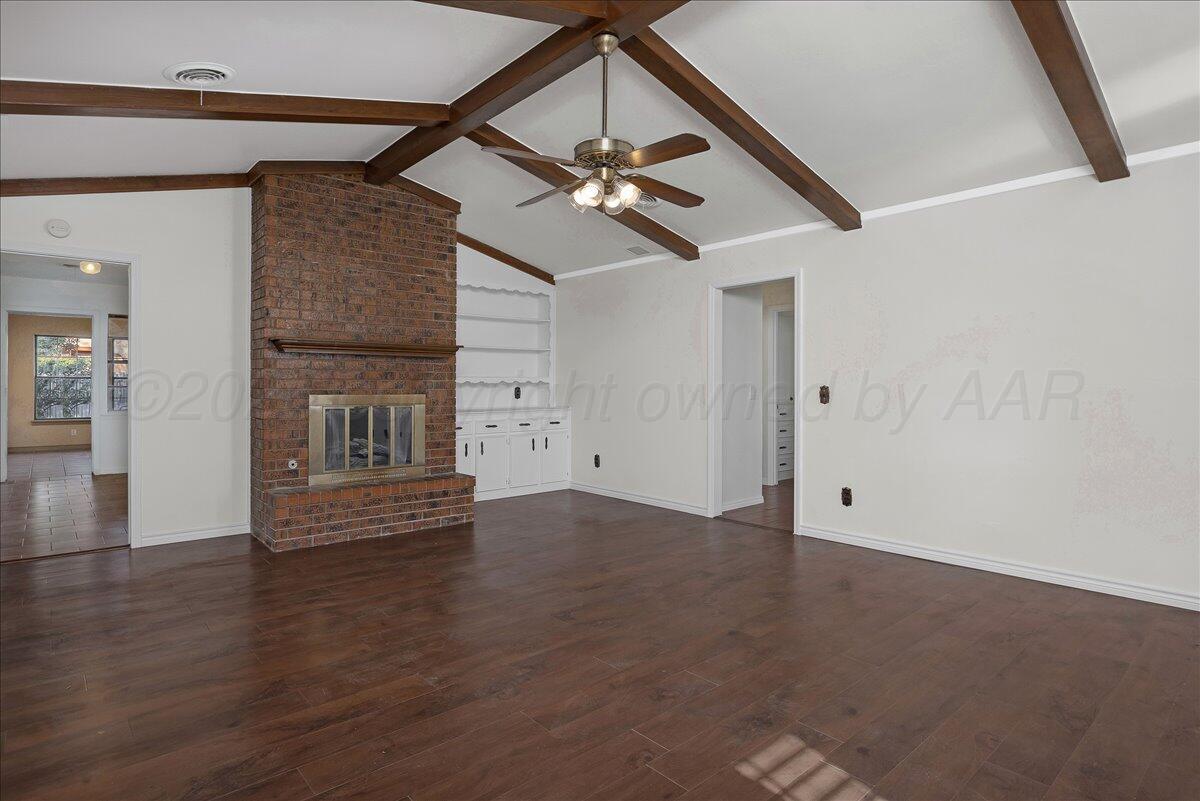7606 Canode Drive Amarillo, TX 79121 - Photo 4 of 30 an empty room with wooden floor ceiling fan and table