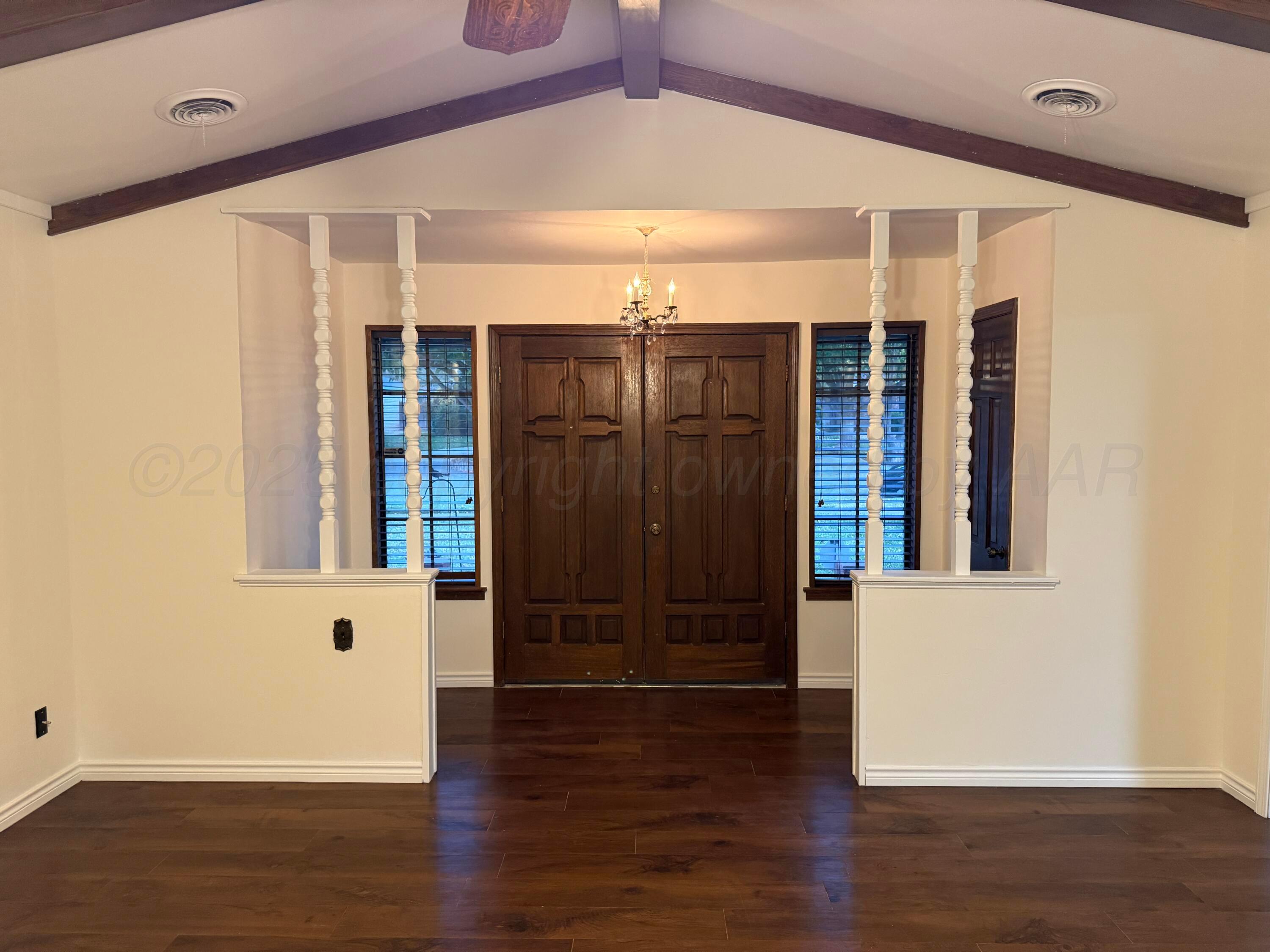 7606 Canode Drive Amarillo, TX 79121 - Photo 5 of 20 an empty room with wooden floor and windows