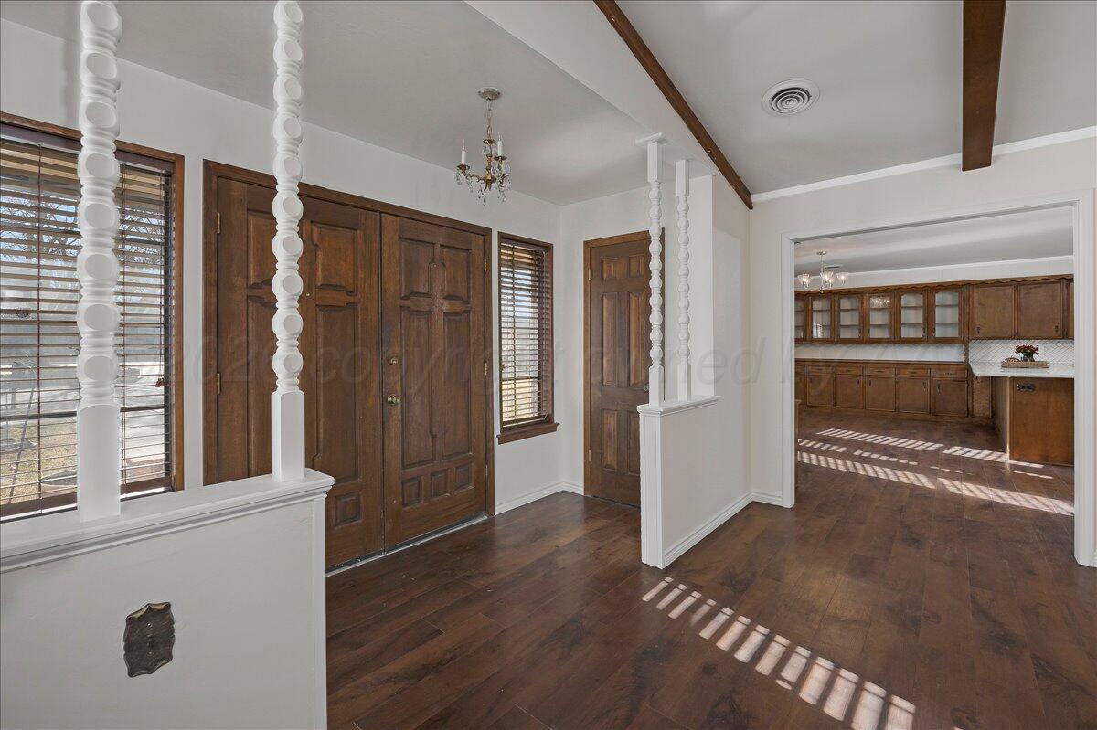 7606 Canode Drive Amarillo, TX 79121 - Photo 6 of 30 an empty room with wooden floor and a fireplace