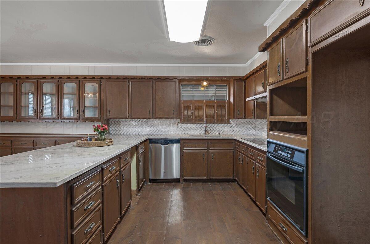 7606 Canode Drive Amarillo, TX 79121 - Photo 10 of 30 a kitchen with a sink stove and cabinets