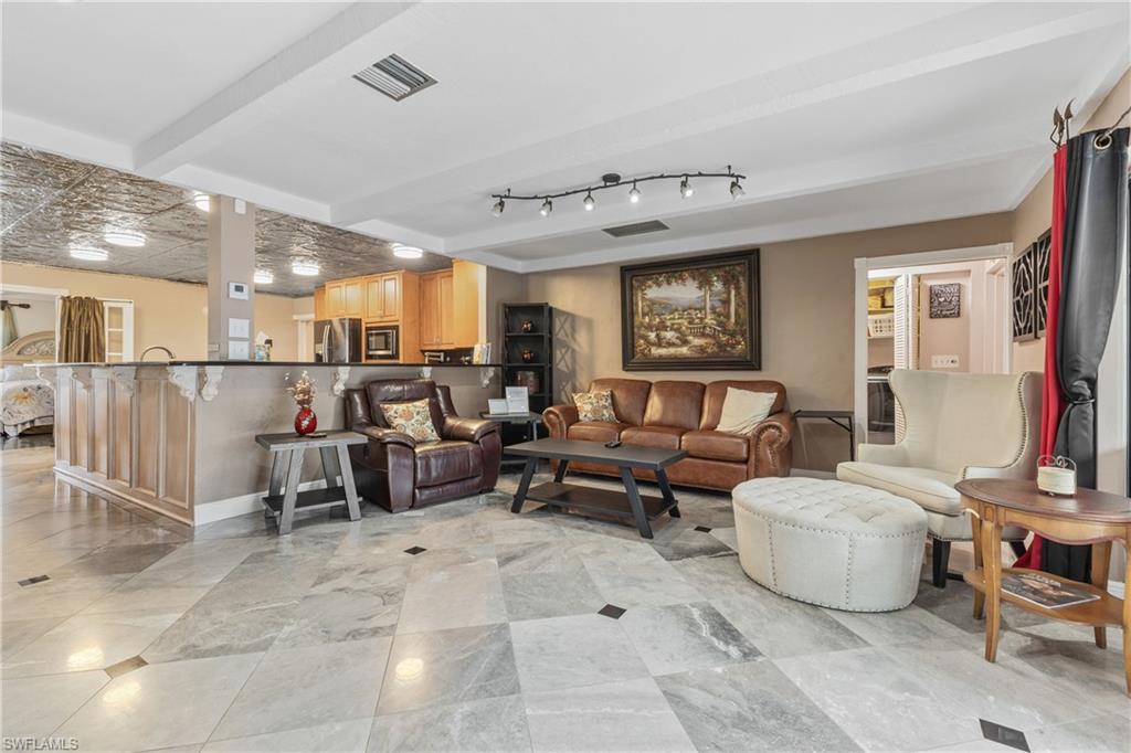 8012 Kansas Road Fort Myers, FL 33967 - Photo 12 of 44 Living room featuring beam ceiling