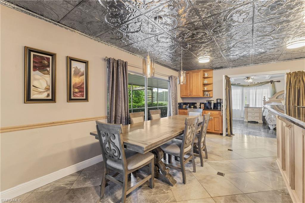8012 Kansas Road Fort Myers, FL 33967 - Photo 13 of 44 Tiled dining room with ceiling fan and a wealth of natural light