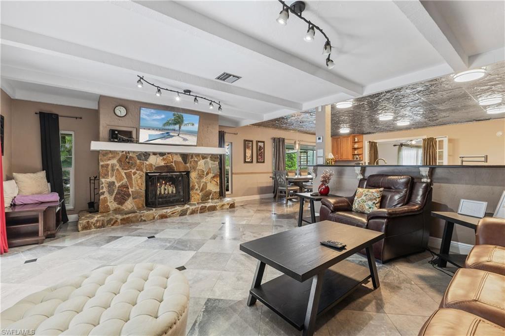 8012 Kansas Road Fort Myers, FL 33967 - Photo 14 of 44 Living room featuring a fireplace and beamed ceiling