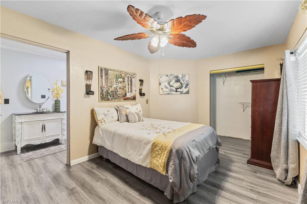 8012 Kansas Road Fort Myers, FL 33967 - Photo 21 of 44 Bedroom featuring ceiling fan, hardwood / wood-style floors, a closet, and sink