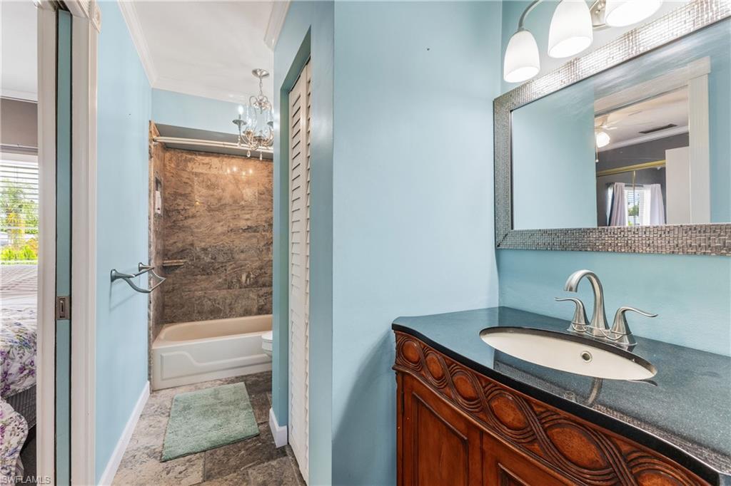 8012 Kansas Road Fort Myers, FL 33967 - Photo 22 of 44 Full bathroom with crown molding, toilet, a chandelier, tub / shower combination, and vanity