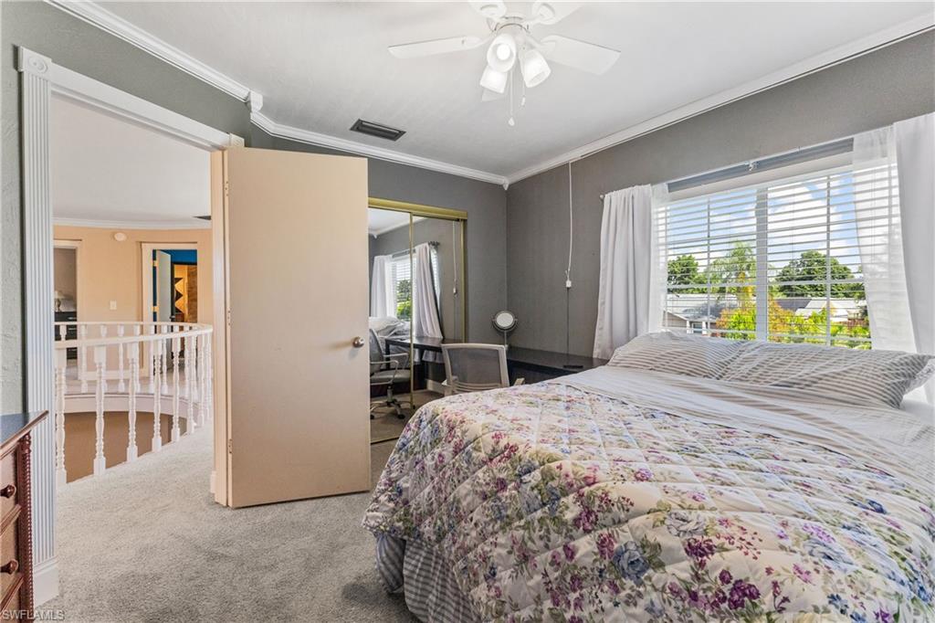 8012 Kansas Road Fort Myers, FL 33967 - Photo 26 of 44 Bedroom with a closet, ceiling fan, carpet, and ornamental molding