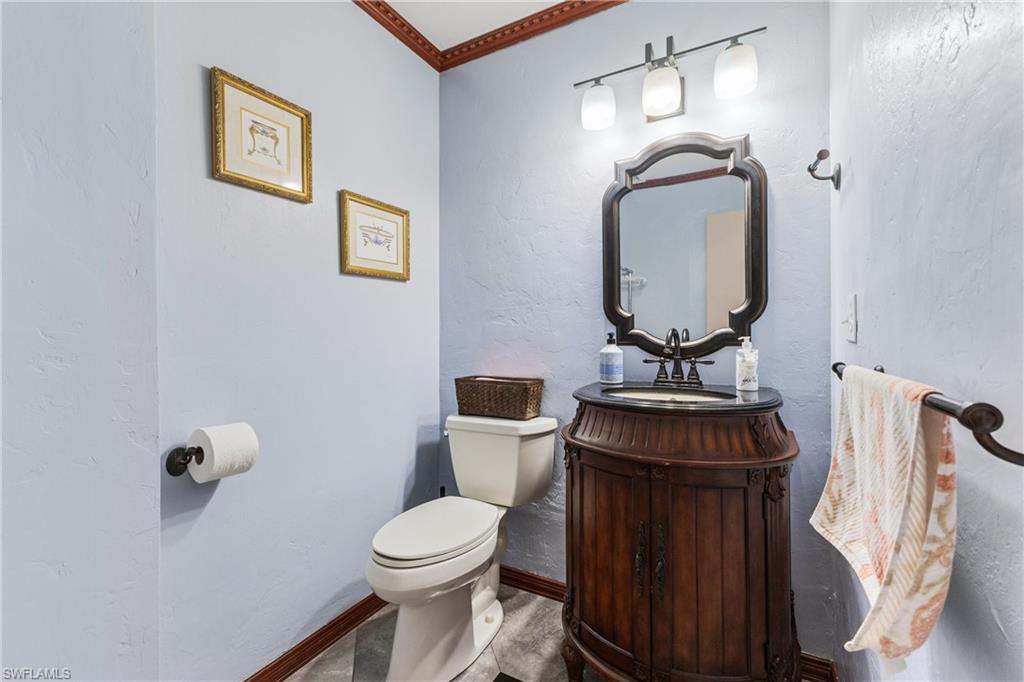8012 Kansas Road Fort Myers, FL 33967 - Photo 30 of 44 Bathroom featuring toilet, crown molding, and vanity